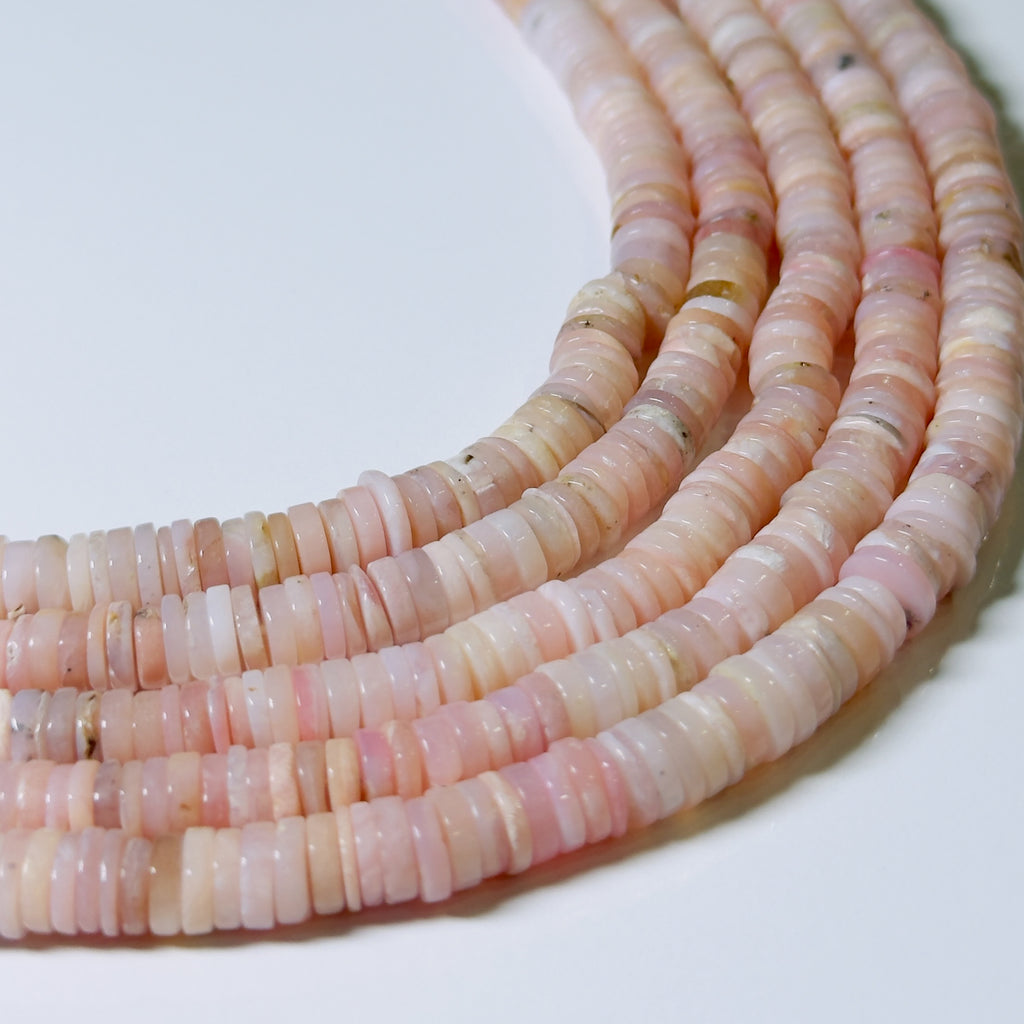 Necklace of pink and white beads on a light background