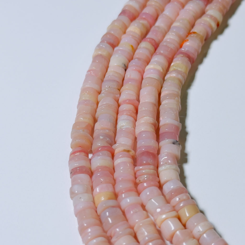 Necklace with pink and white marbled beads on a white background