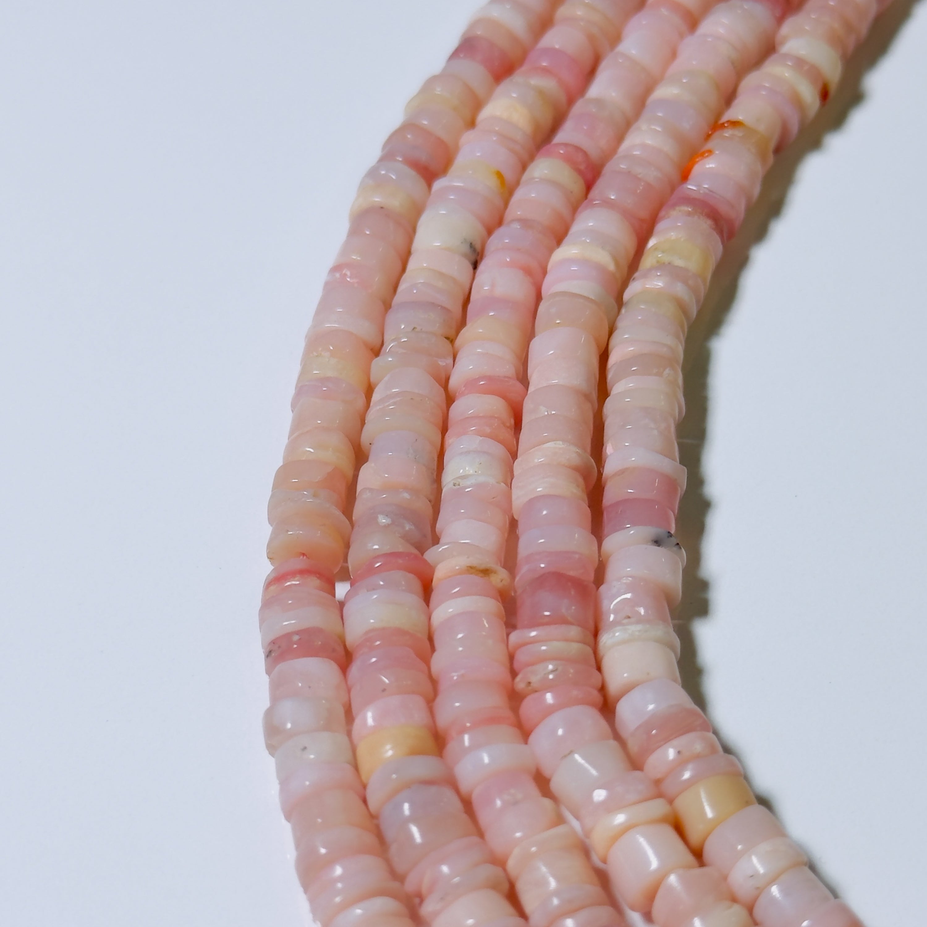 Necklace with pink and white marbled beads on a white background
