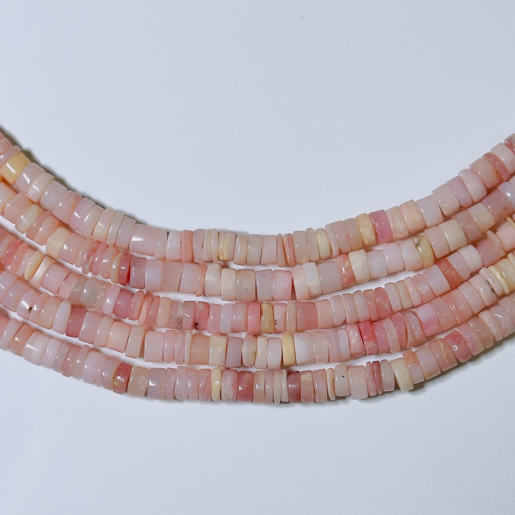 Necklace with pink and white beads on a light gray background