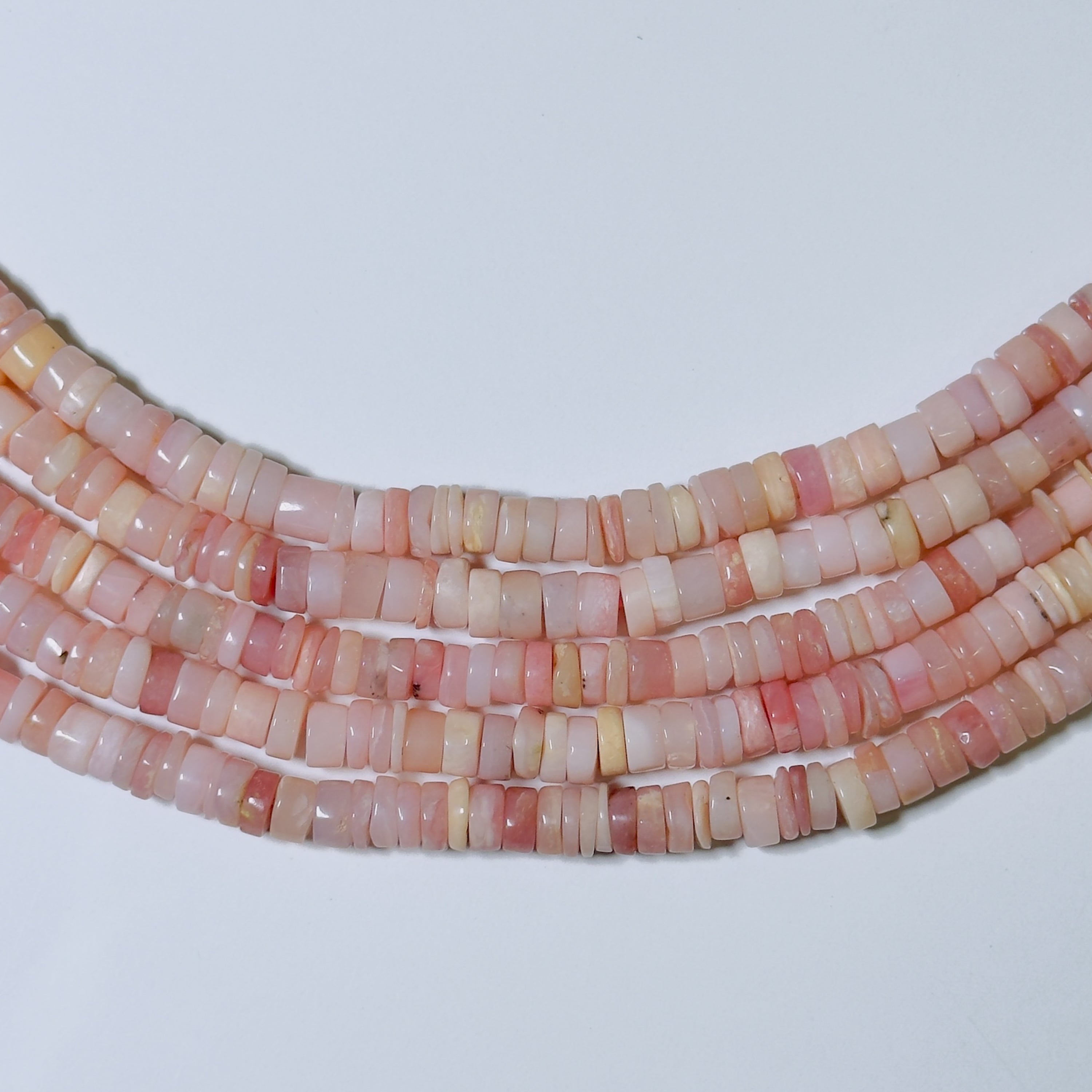 Necklace with pink and white beads on a light gray background