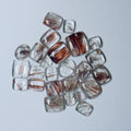 Collection of clear and Red gemstones on a White background