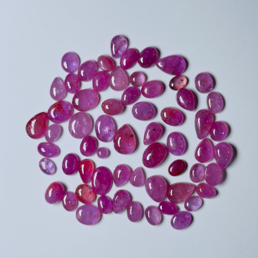 Pink gemstones on a light gray background