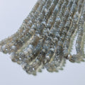 String of small gray beads on a white background