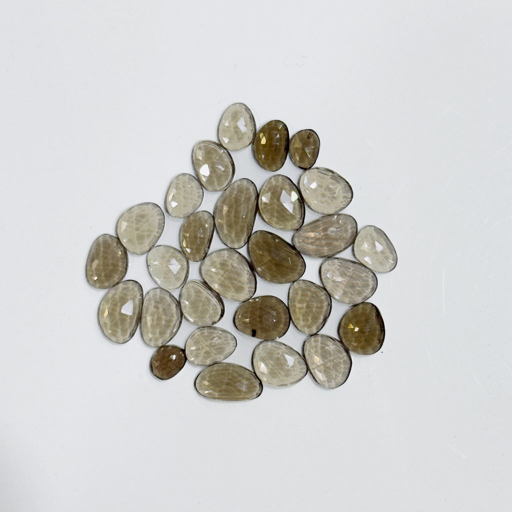 Collection of brown and beige stones on a white background