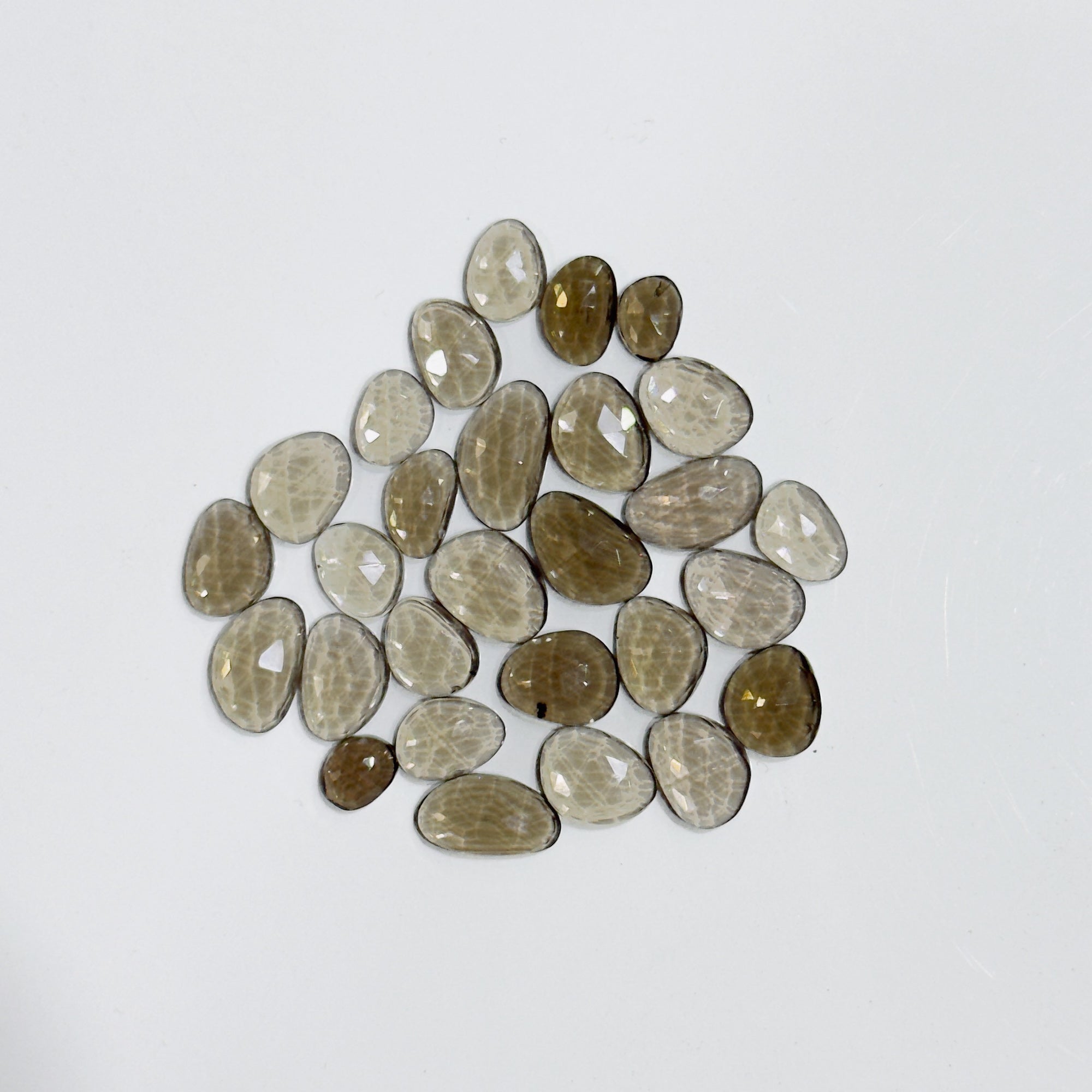 Collection of brown and beige stones on a white background