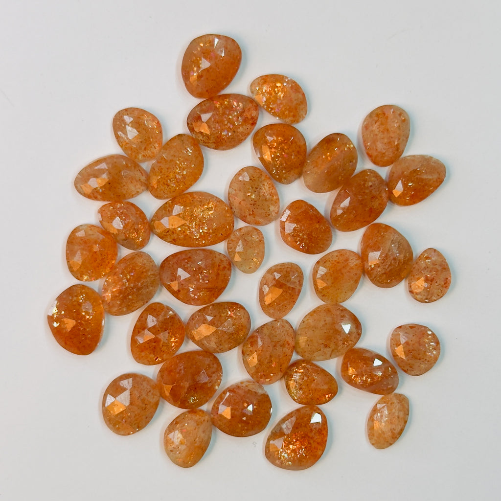 Orange gemstones on a light gray background