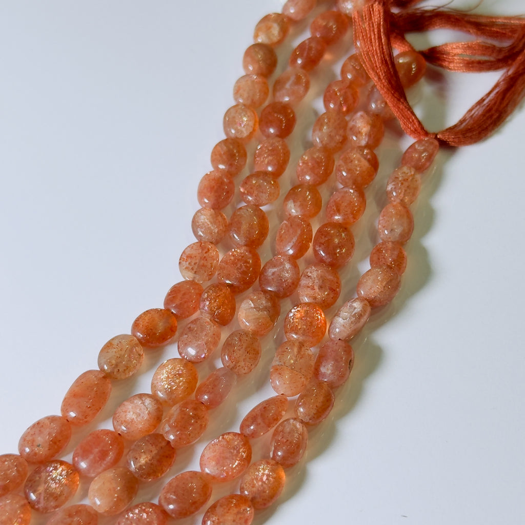 Necklace with orange beads on a white background