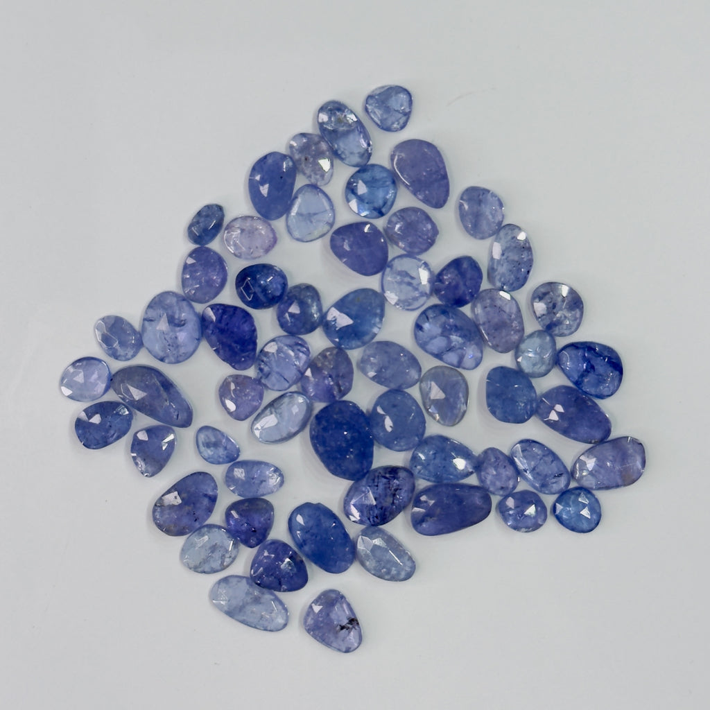 Collection of blue gemstones on a light gray background