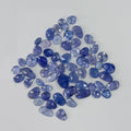 Collection of blue gemstones on a light gray background
