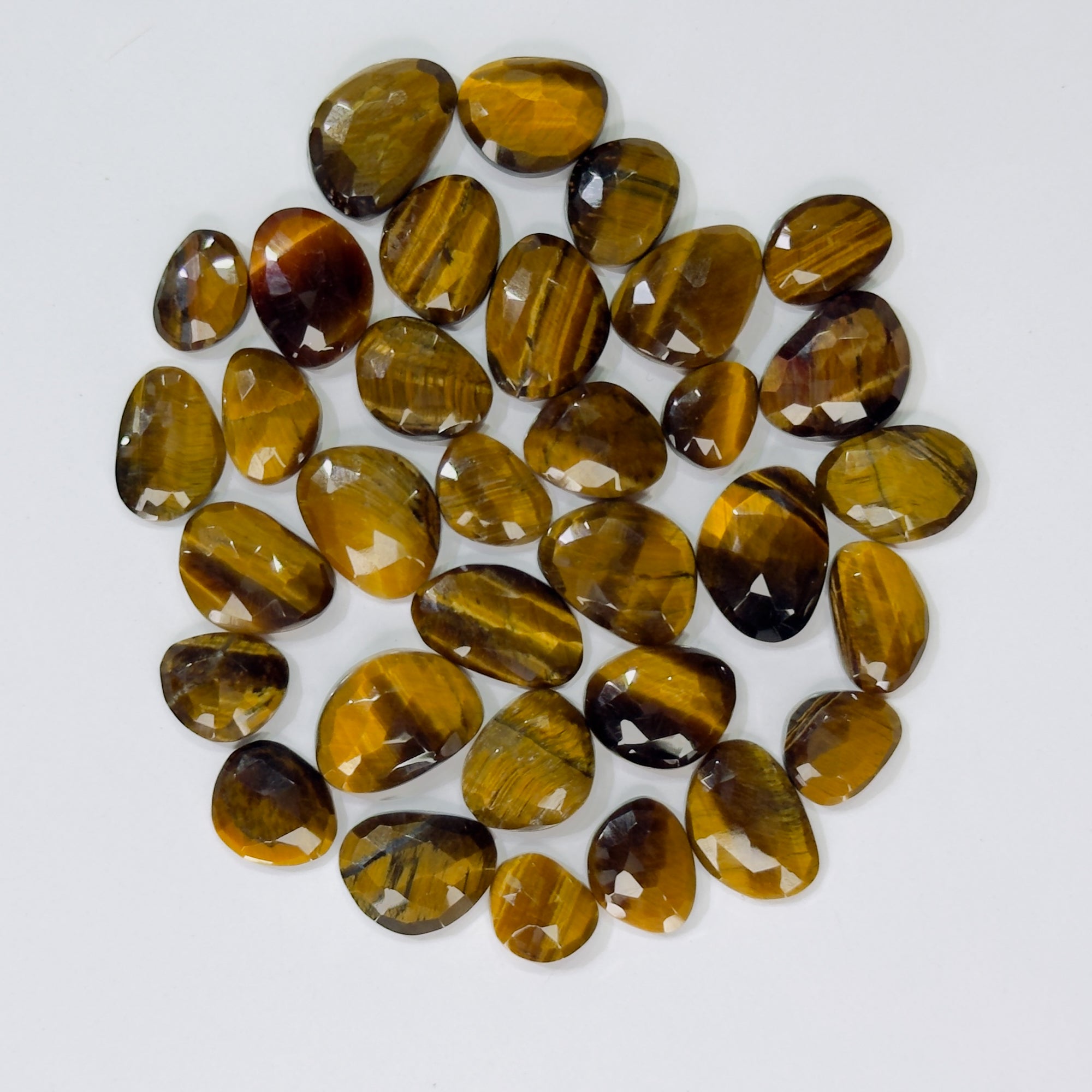 Collection of tiger eye stones on a white background