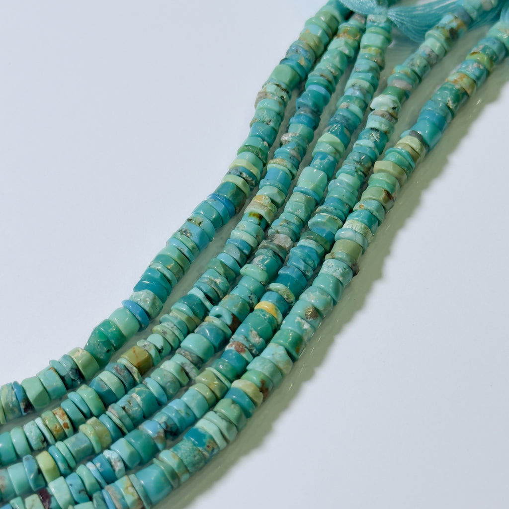 Turquoise bead necklace on a light blue background