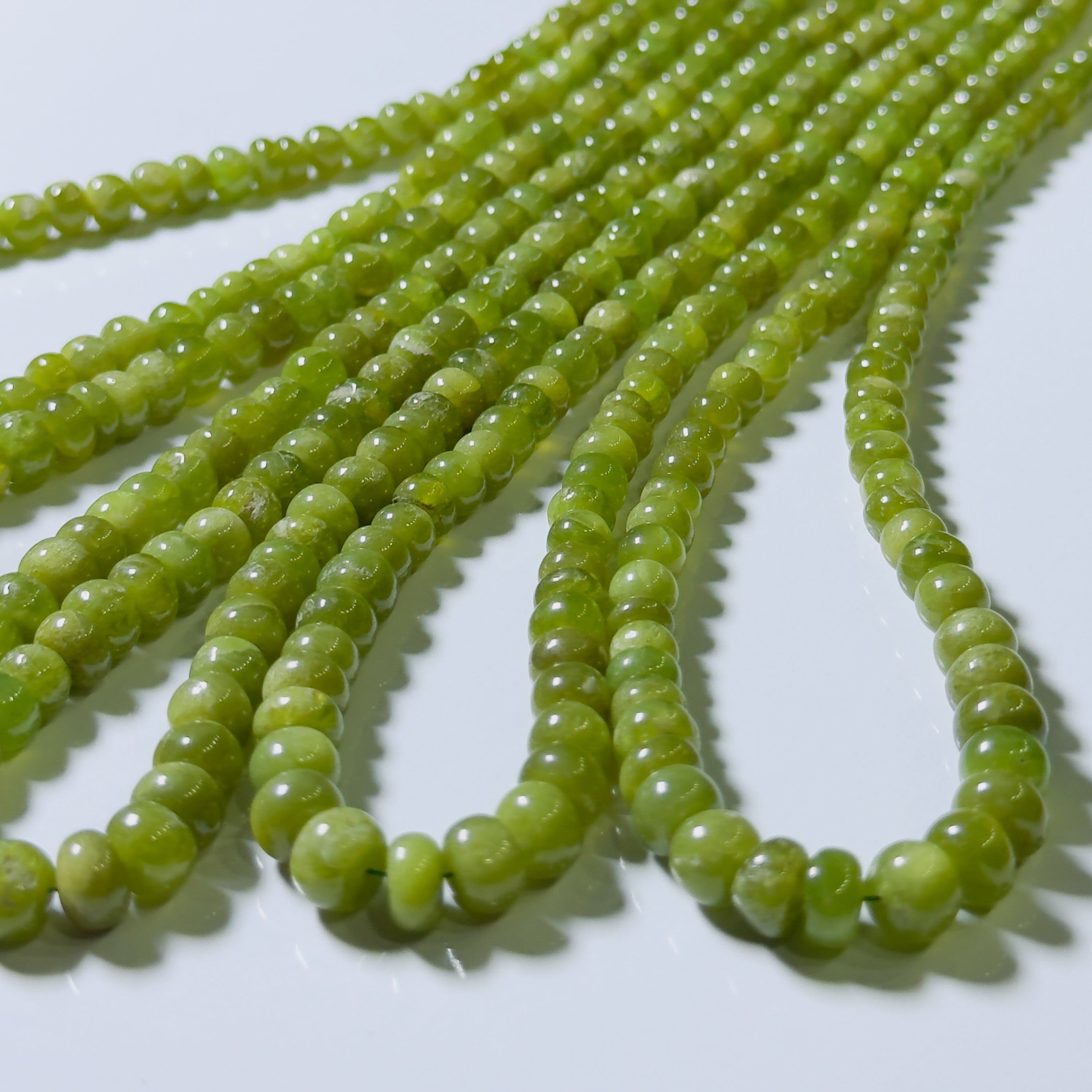 Green bead strings on a white background