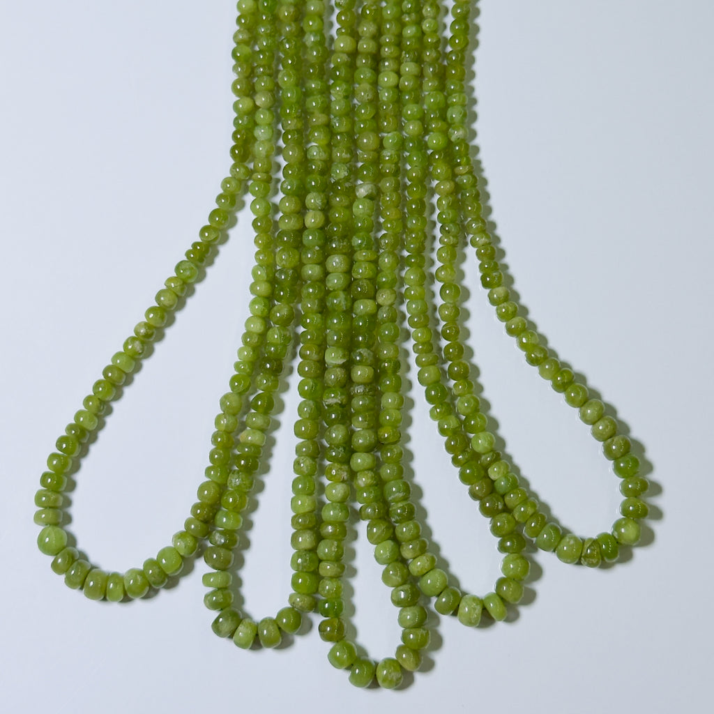 String of green beads on a white background