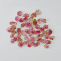 Pink and red gemstones on a white background