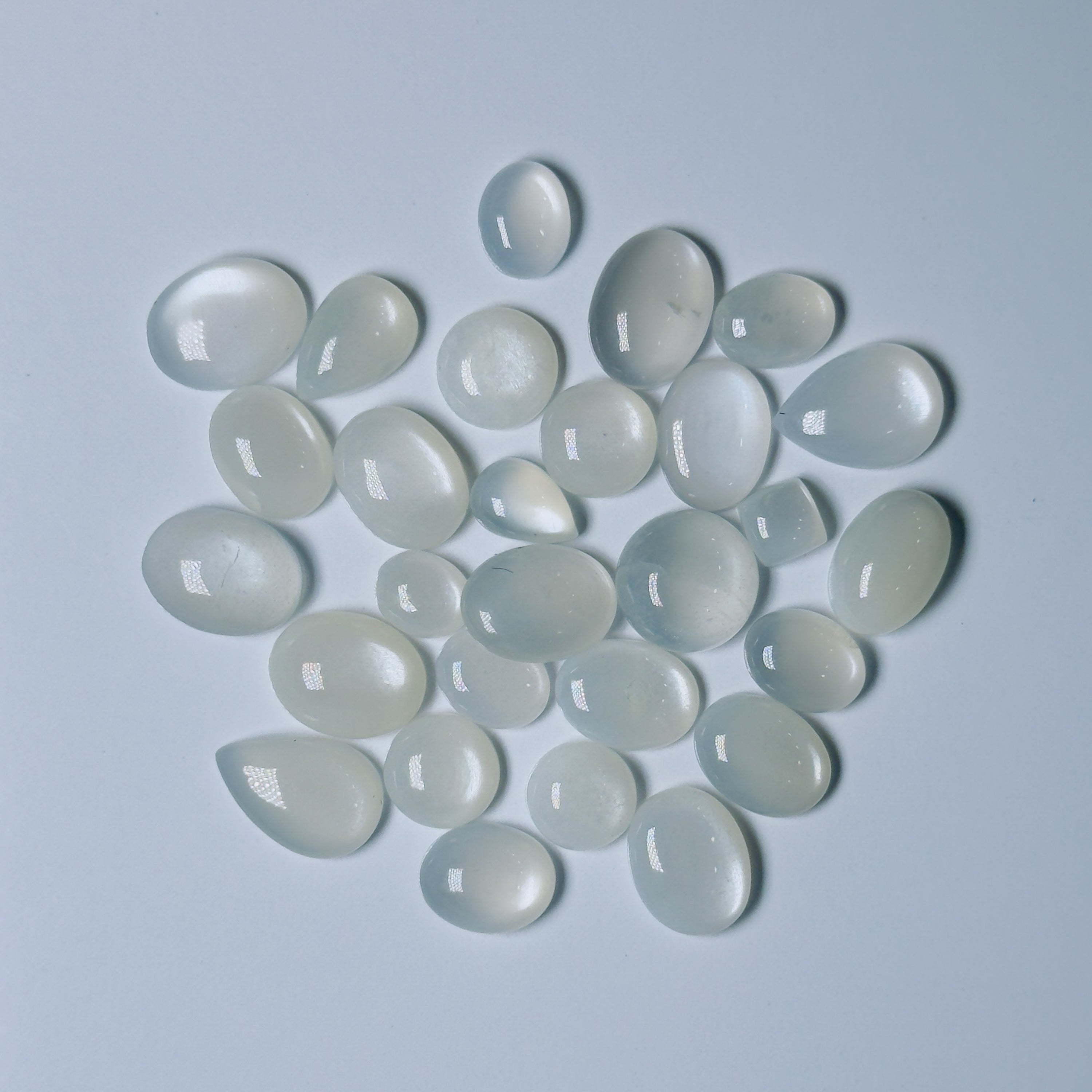 Collection of  White teardrop-shaped stones on a White background